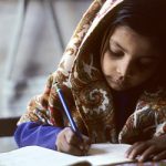 A young girl does her school work in Karachi, Pakistan.